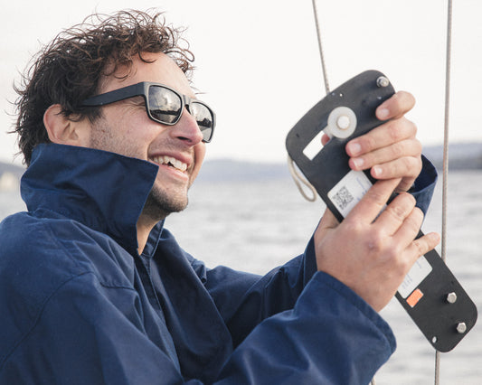Working a winch handle on deck in the navy oilskin Mariner's Smock