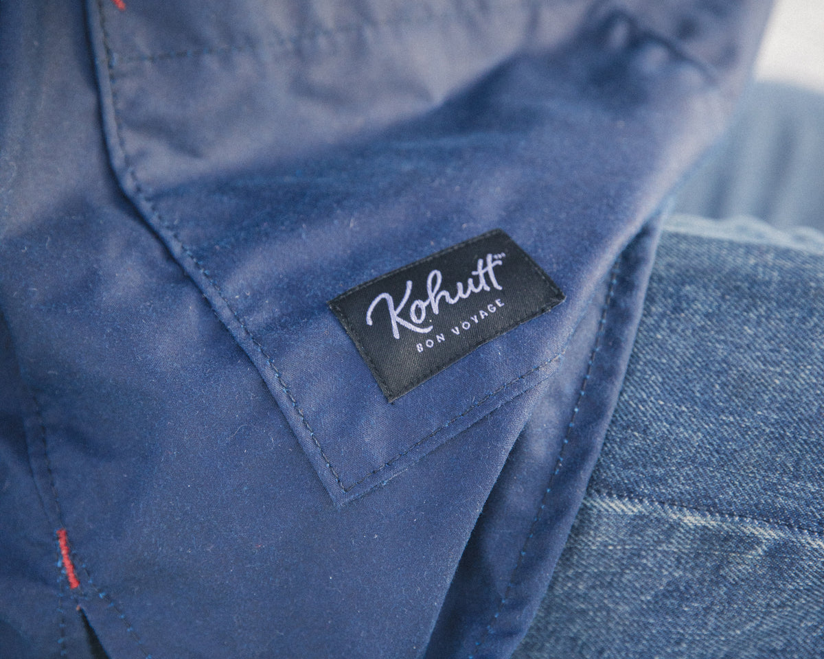 Kohutt label and red bar tack detail on the navy oilskin Mariner's Smock