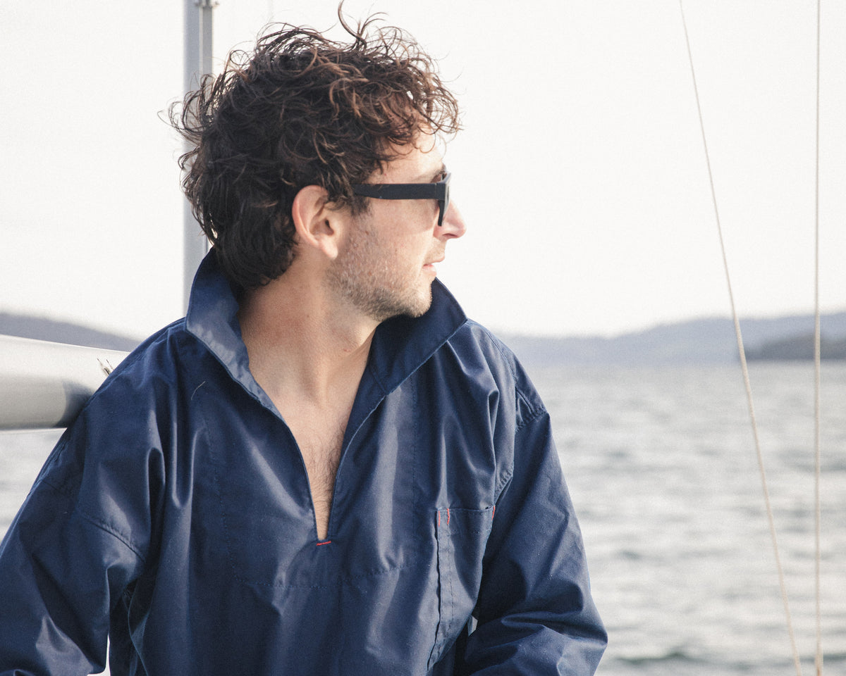 Holding a coiled line on deck in the navy oilskin Mariner's Smock