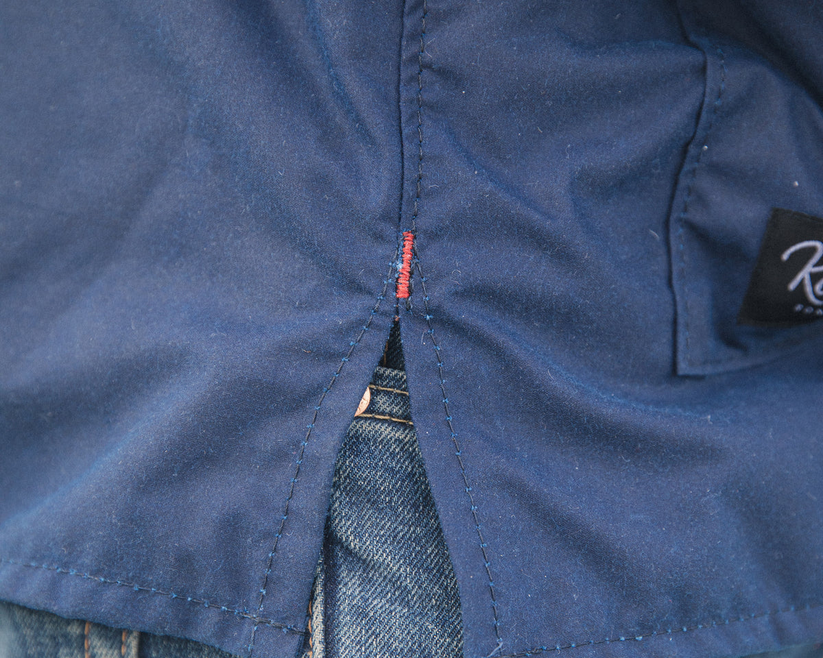 Split hem with red bar tack on the Mariner's Smock