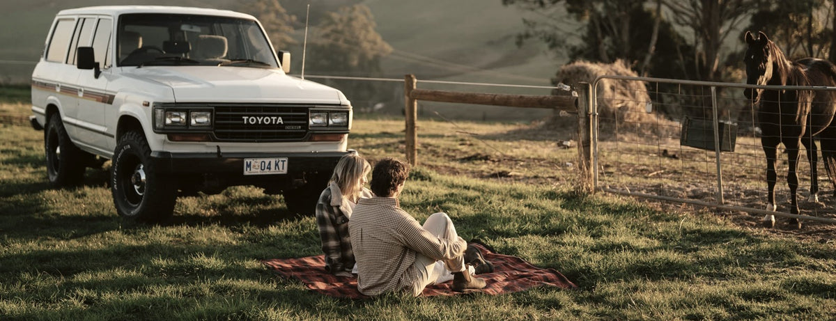 Picnic on a Kohutt rug beside a Toyota Land Cruiser